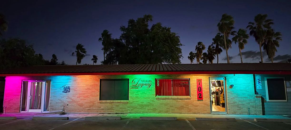 Shop exterior lit in rainbow colors at dusk