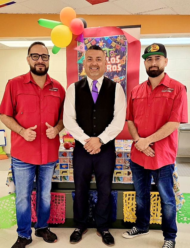 Minga's Legacy barbers at a community school event
